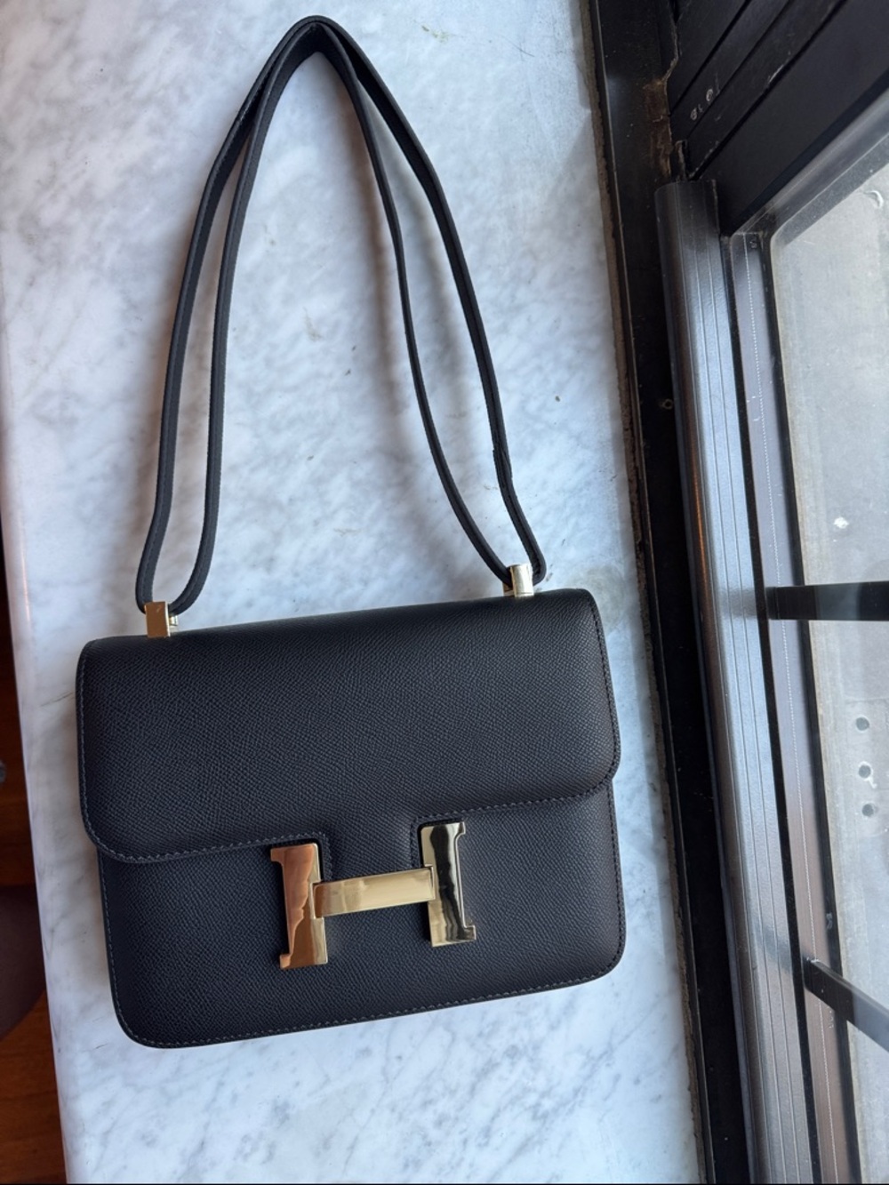 Black Leather Shoulder Bag with Gold Hinge Accent